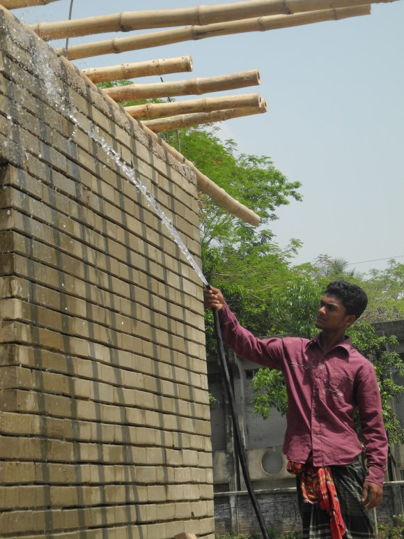 Soaking the earth blocks in water